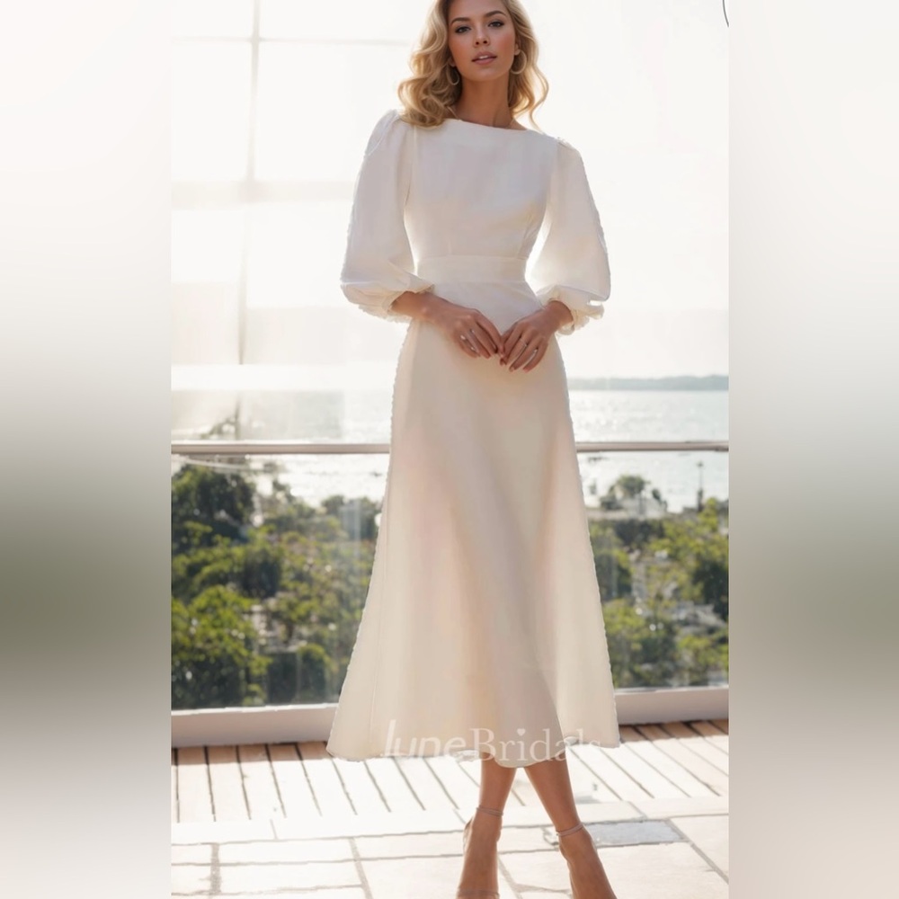 UPDATED: Never worn, ivory a-line midi dress with billow sleeve. Size 6.